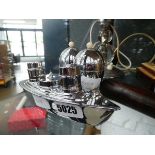 Boat shaped cruet set and a pair of egg cups