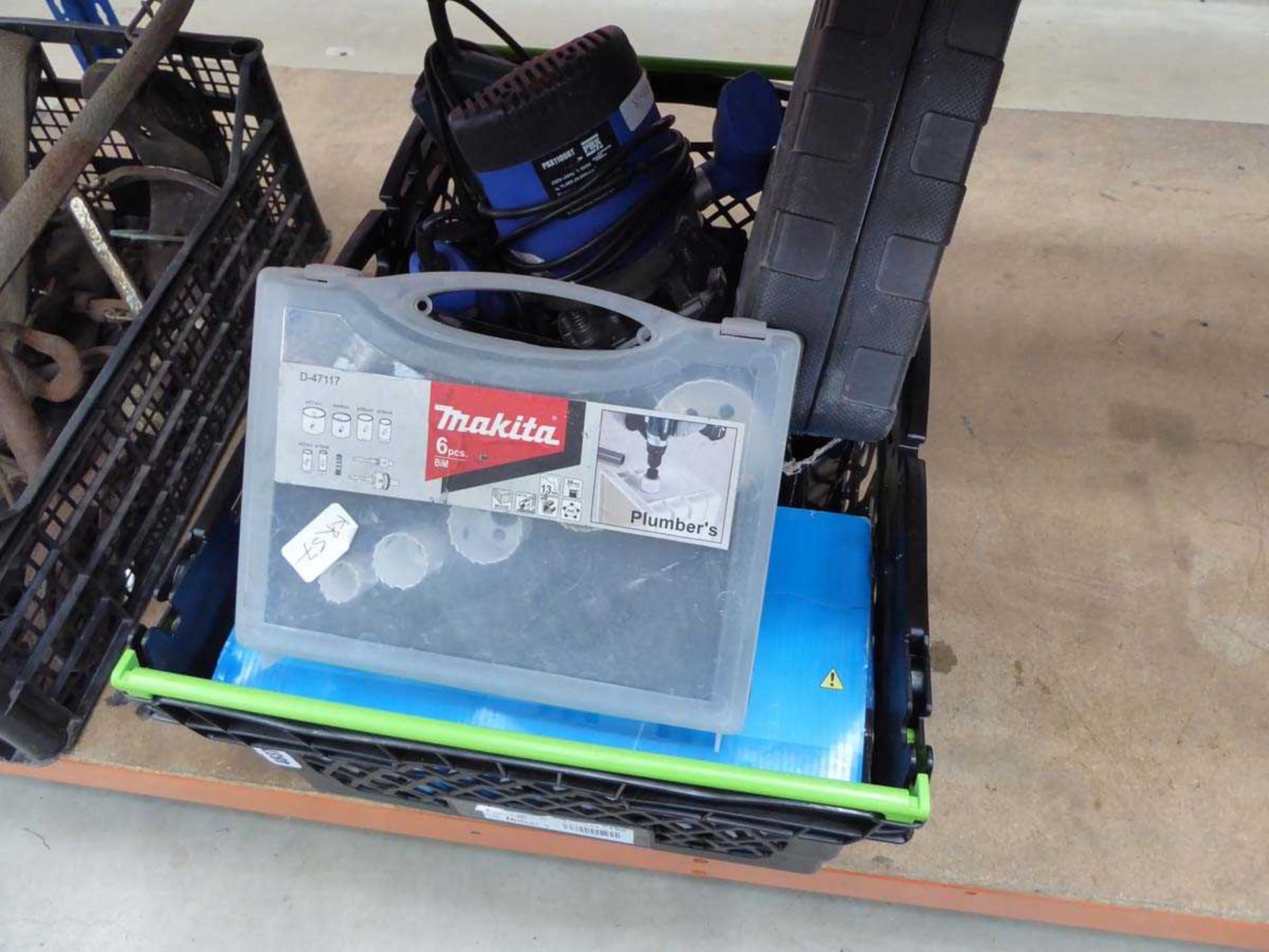Box containing pole cutters, router, belt sander and various other tools