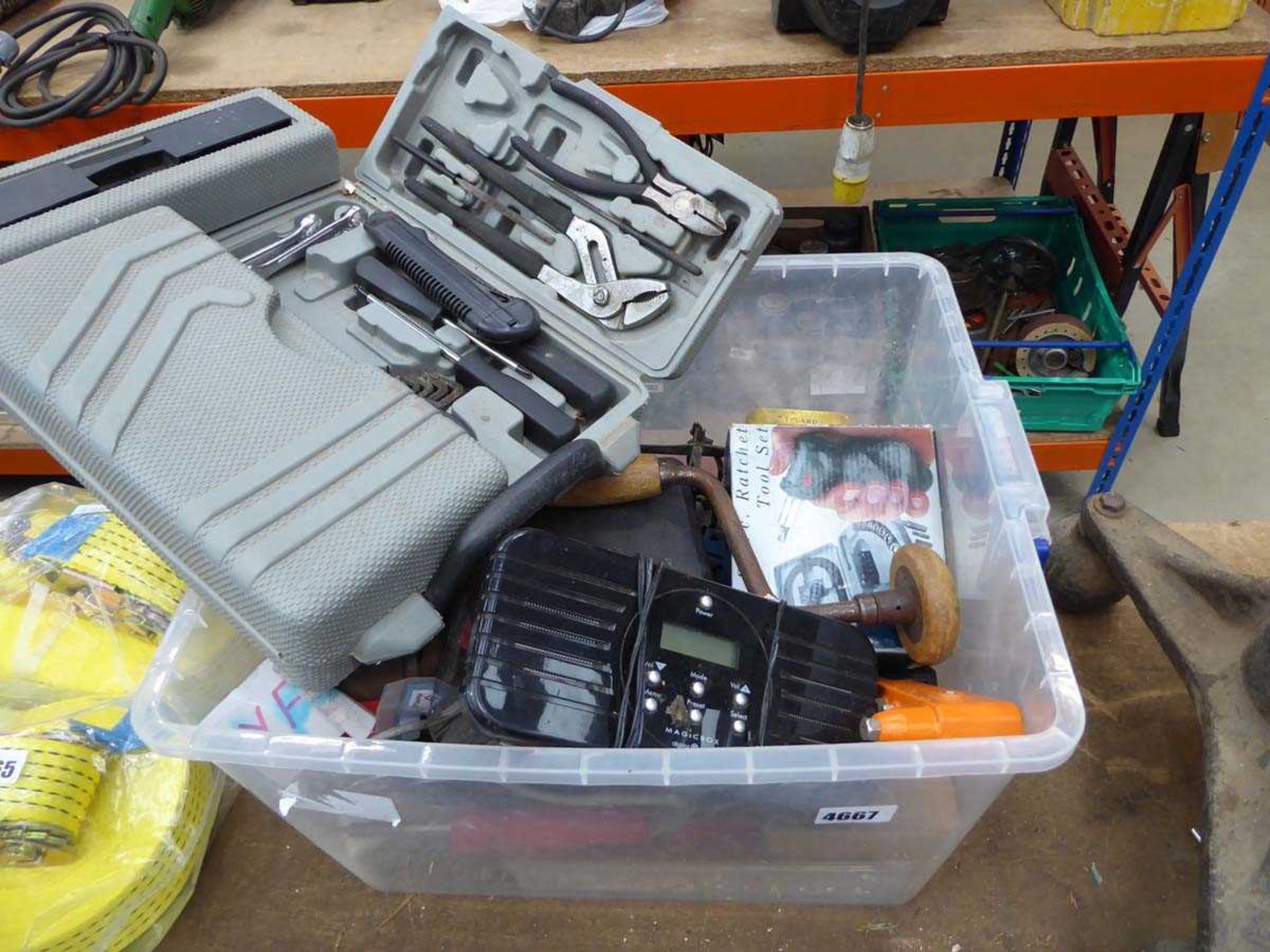 Plastic box containing various tools, radio, riveter, etc