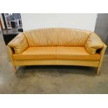 A 1970's Danish tan leather curved 'banana' sofa designed by Mogens Hansen, Model MH535, on beech