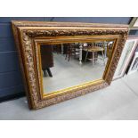 Rectangular bevelled mirror in ornate gilt frame
