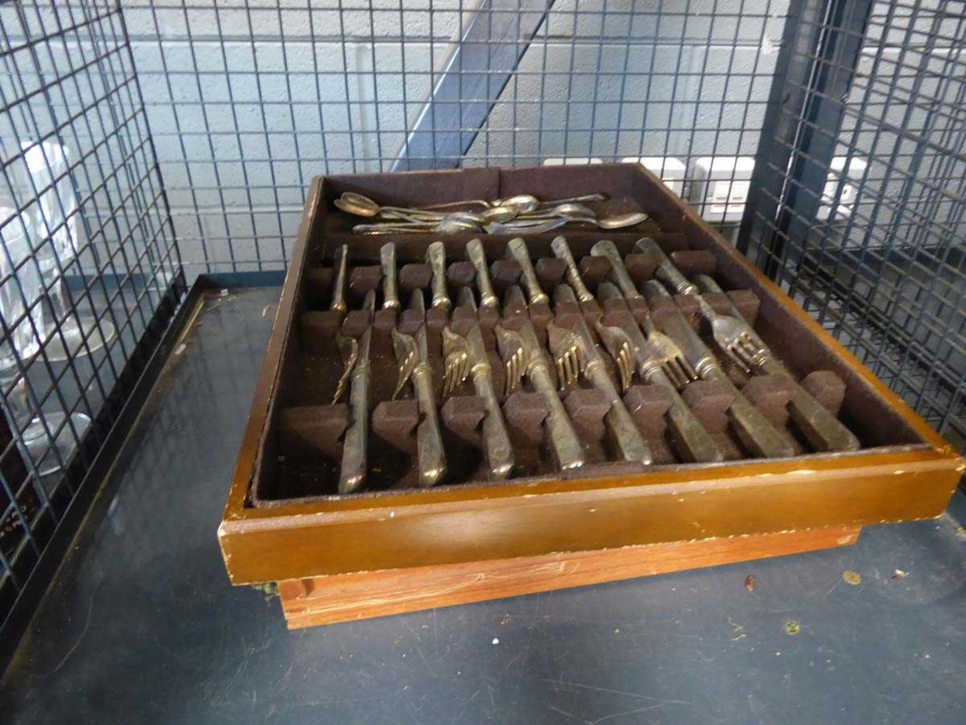 Cage containing quantity of lose and boxed cutlery
