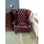 Maroon leather affect wing back armchair