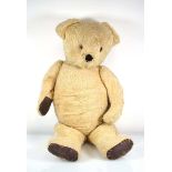 A plush, covered and straw filled teddy bear in the manner of Merrythought, circa 81 cm