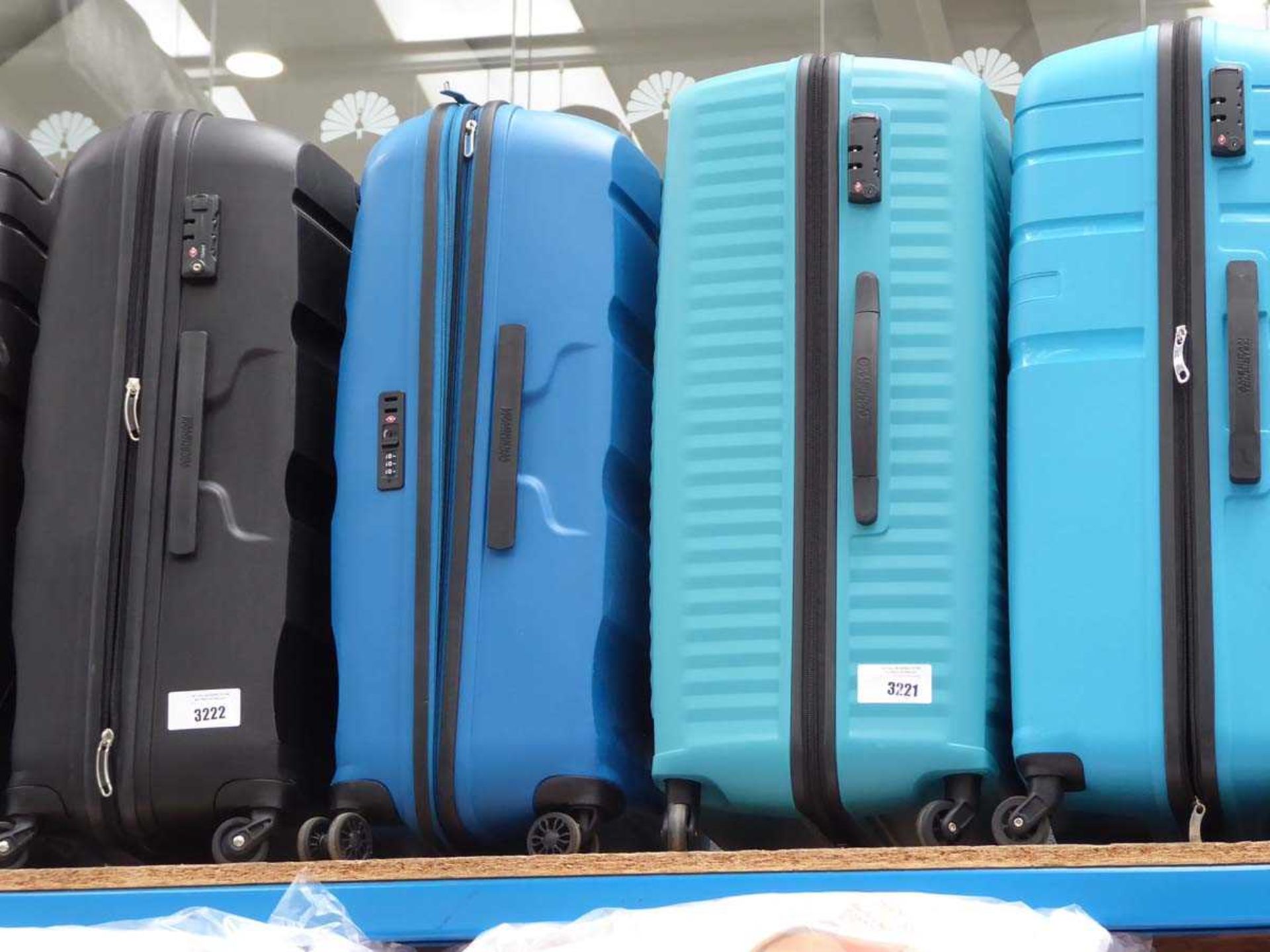 +VAT One dark blue and one light green large hard shelled American Tourister suitcases
