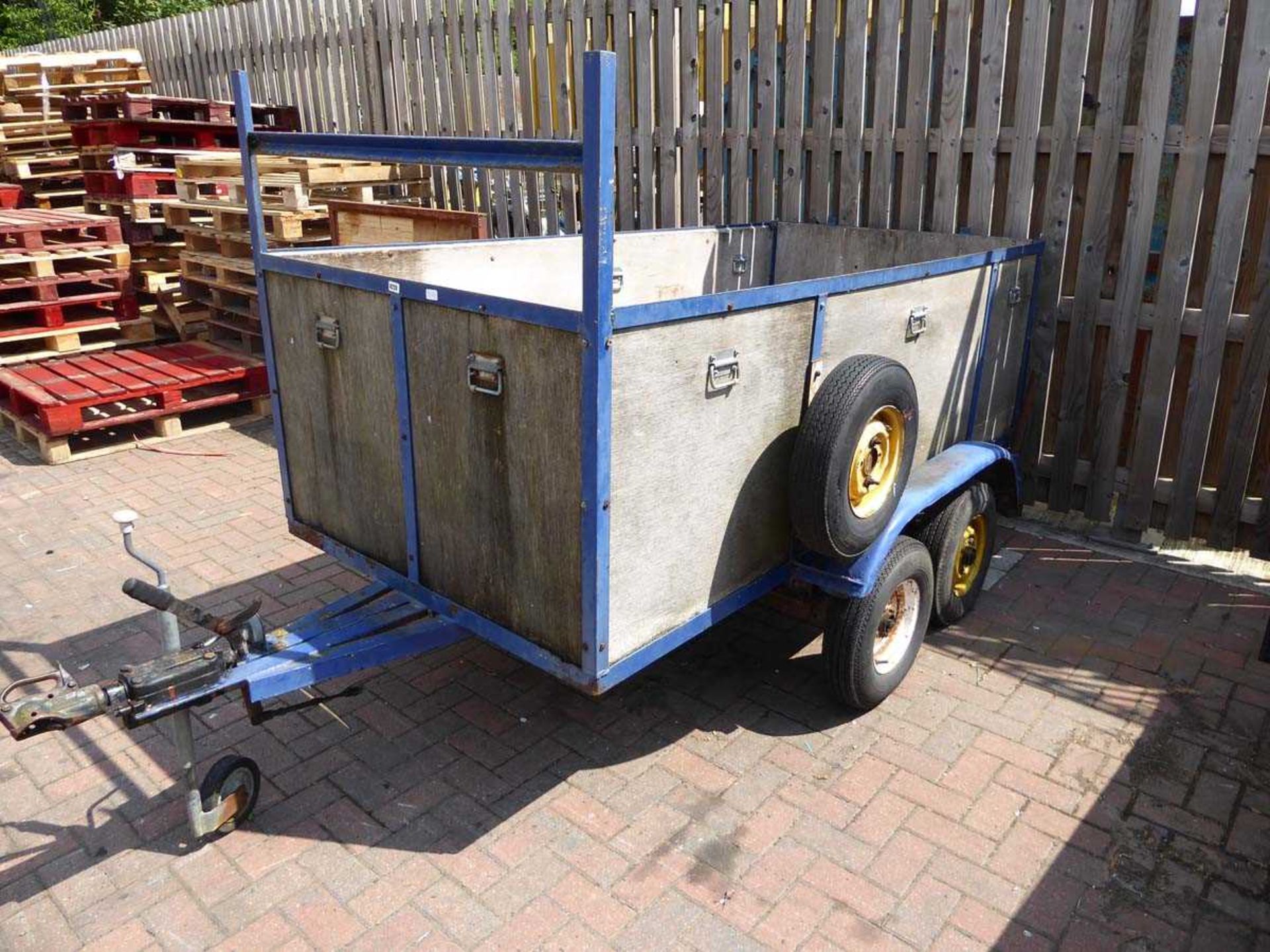 Twin axle high body wood and metal framed trailer