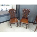 Pair of carved oak Victorian hall chairs