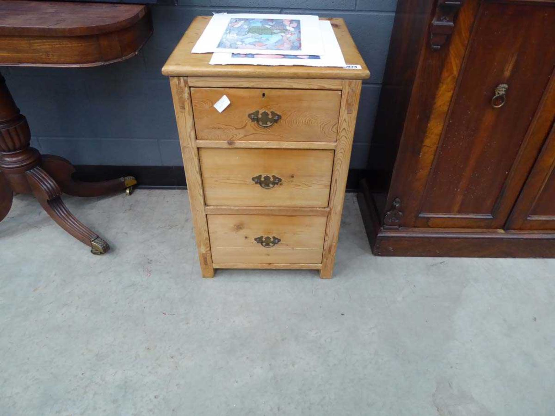 Stripped pine three drawer bedside cabinet