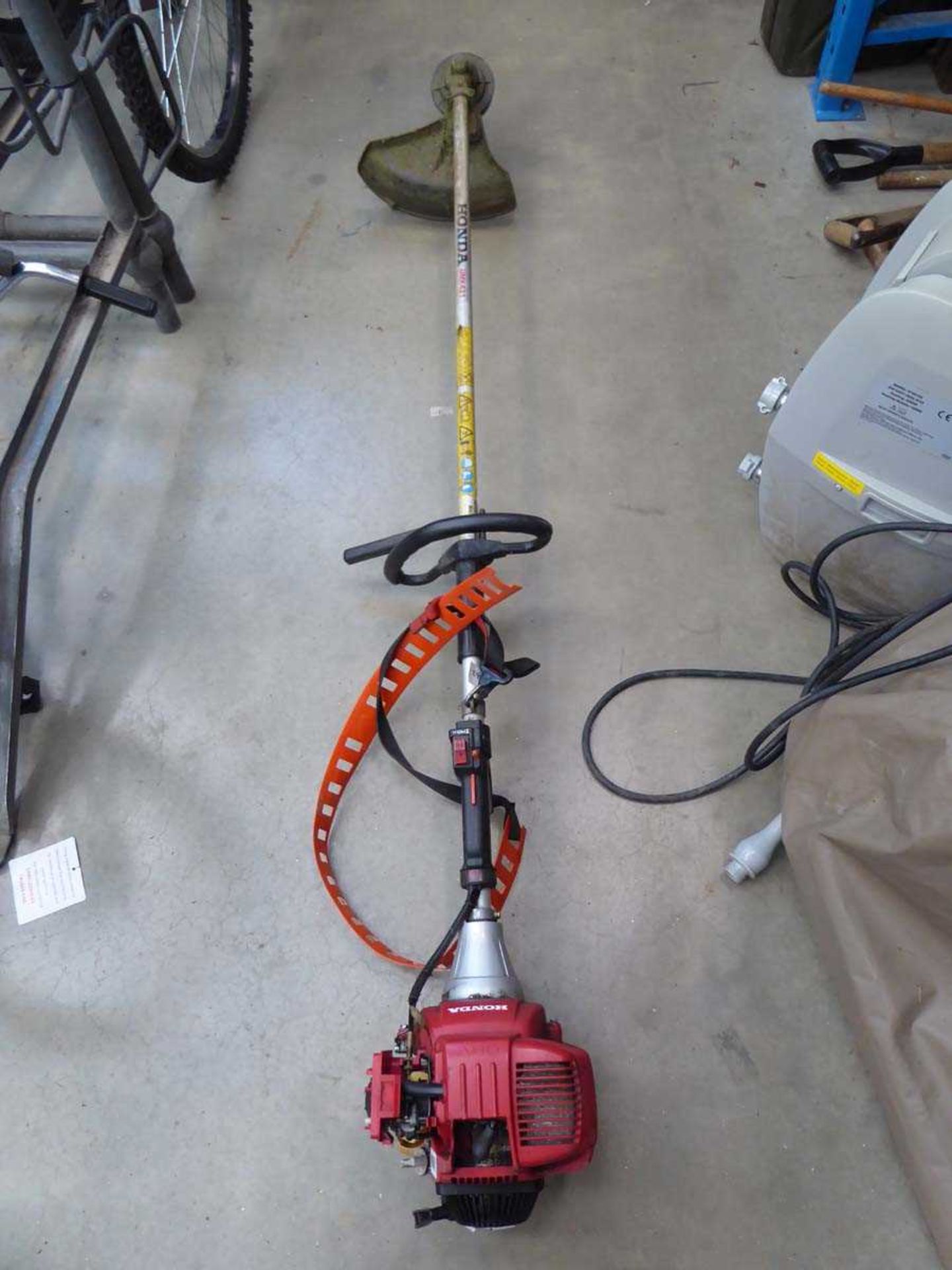 Red Honda petrol powered strimmer