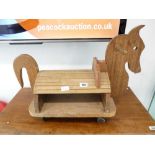 Child's ride on wooden horse on casters