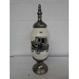 Large ceramic urn with glass studded chrome stand and lid, depicting a vintage motor vehicle