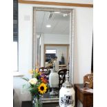 +VAT Large rectangular wall mirror with silver coloured decorative frame (29 x 64in. approx.)