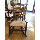 Dark oak rush seated rocking chair