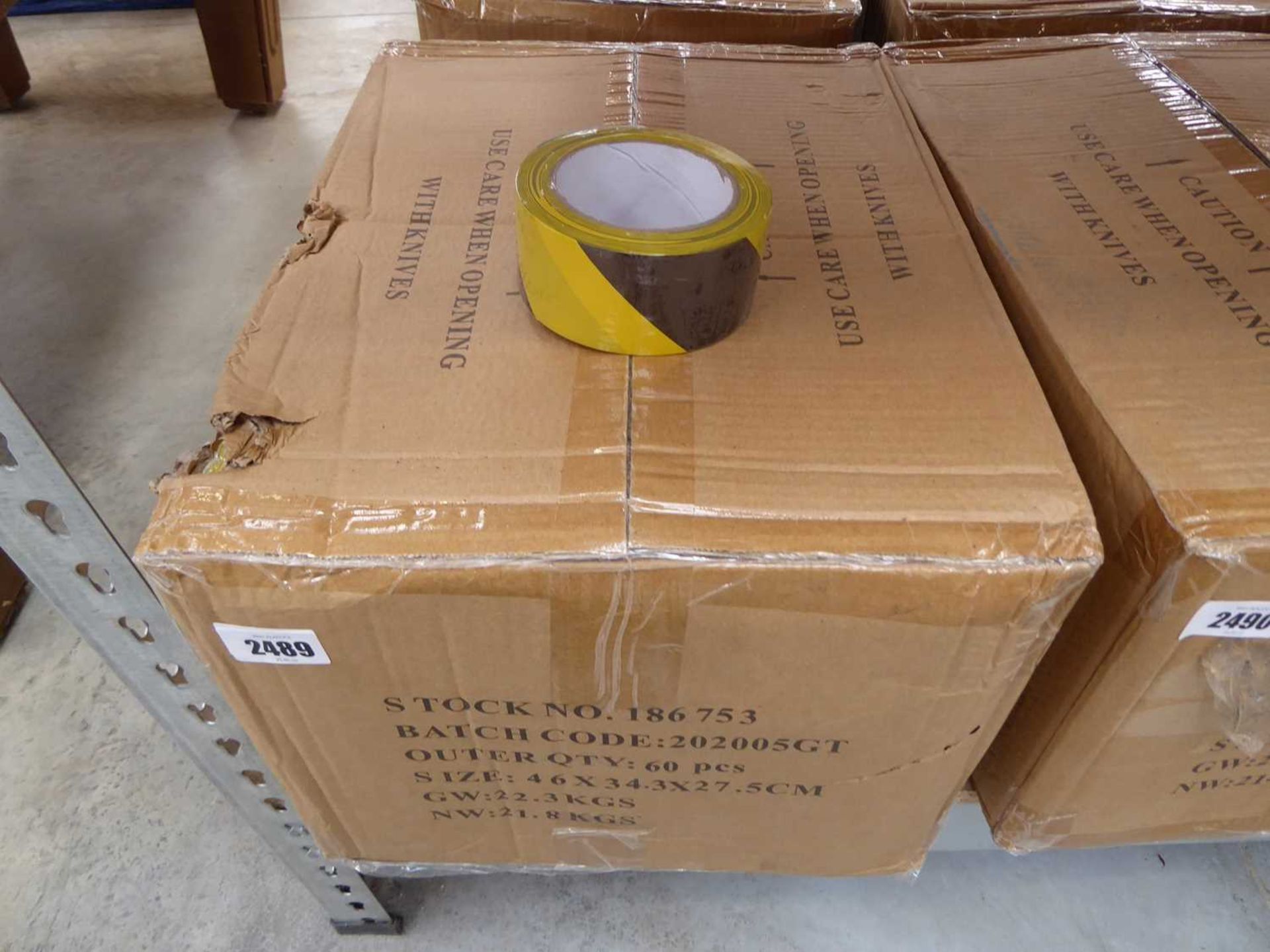 Box containing 60 rolls of black and yellow hazardous tape
