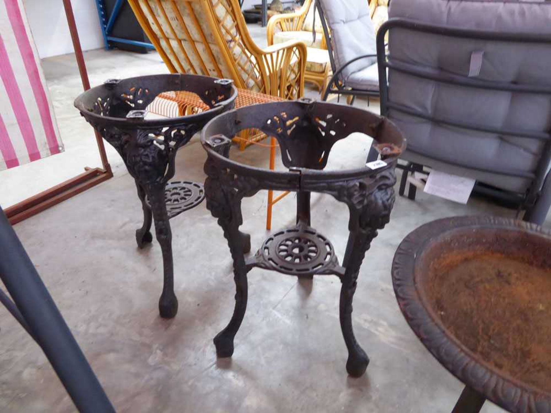 Pair of 3 legged cast iron table frames with decorative lion features