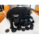 Cased Minolta 7000 auto focus film camera with various lenses including 49mm auto focus 70-210mm