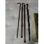 Four walking sticks including one with mother of pearl inlays and one with brass horse head handle