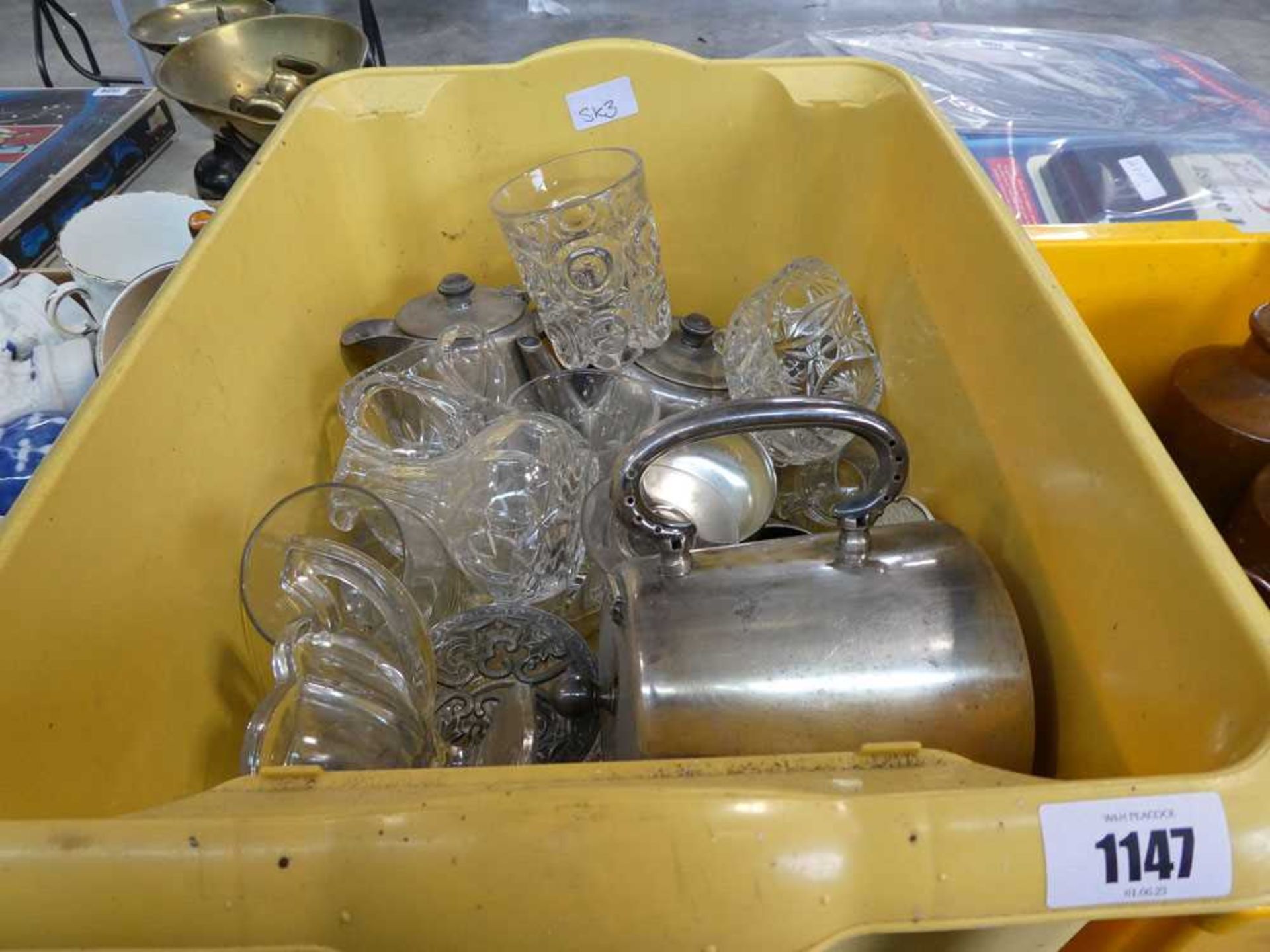 2 yellow boxes containing a quantity of glassware and silver coloured teapots etc.
