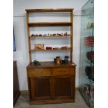 Early 20th Century stained pine dresser with sliding doors to base and plate rack above