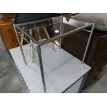Modern metal framed coffee table with glass surface