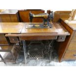 Singer sewing machine on stand with manual powered treadle base, serial Y4527792