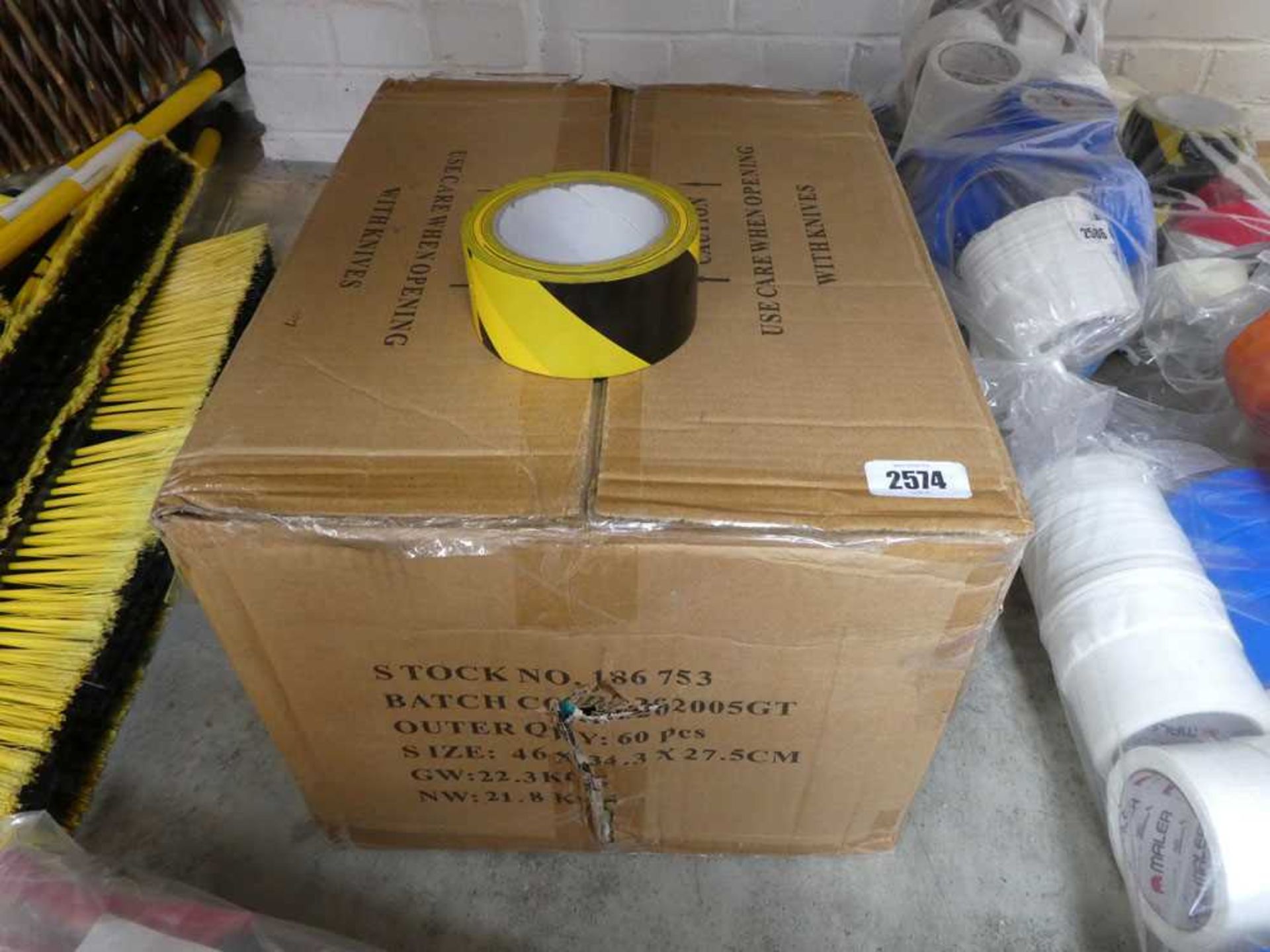 Box containing approximately 60 rolls of black & yellow hazardous tape