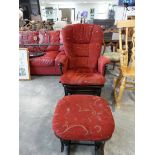 Wooden framed rocking chair with red upholstered cushion and matching footstool