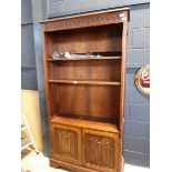 Dark oak open fronted bookcase with double door cupboard storage below