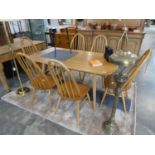 Blonde ercol dining table with 6 matching stick back dining chairs