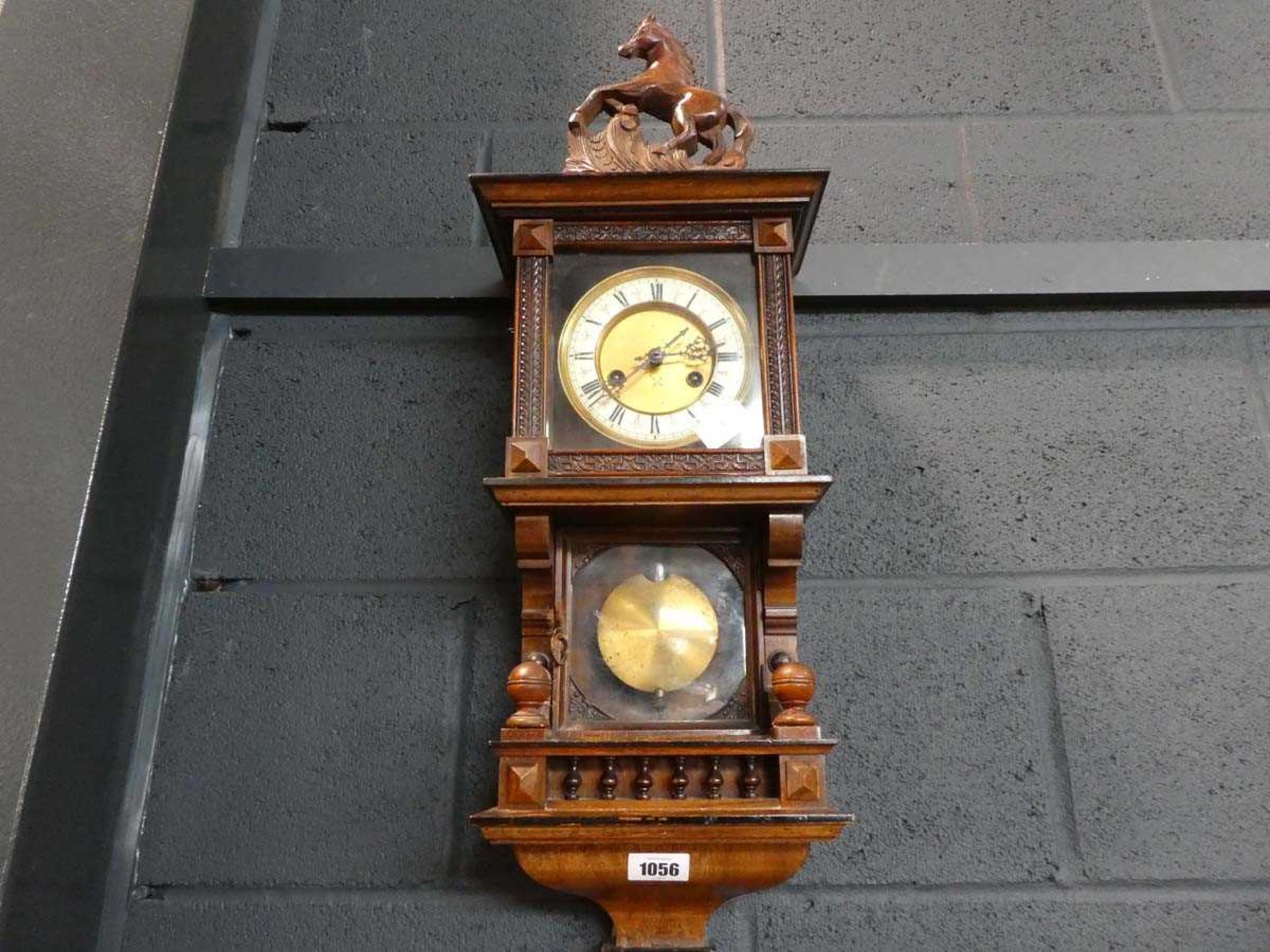 Mahogany cased clock with horse venial and pendulum