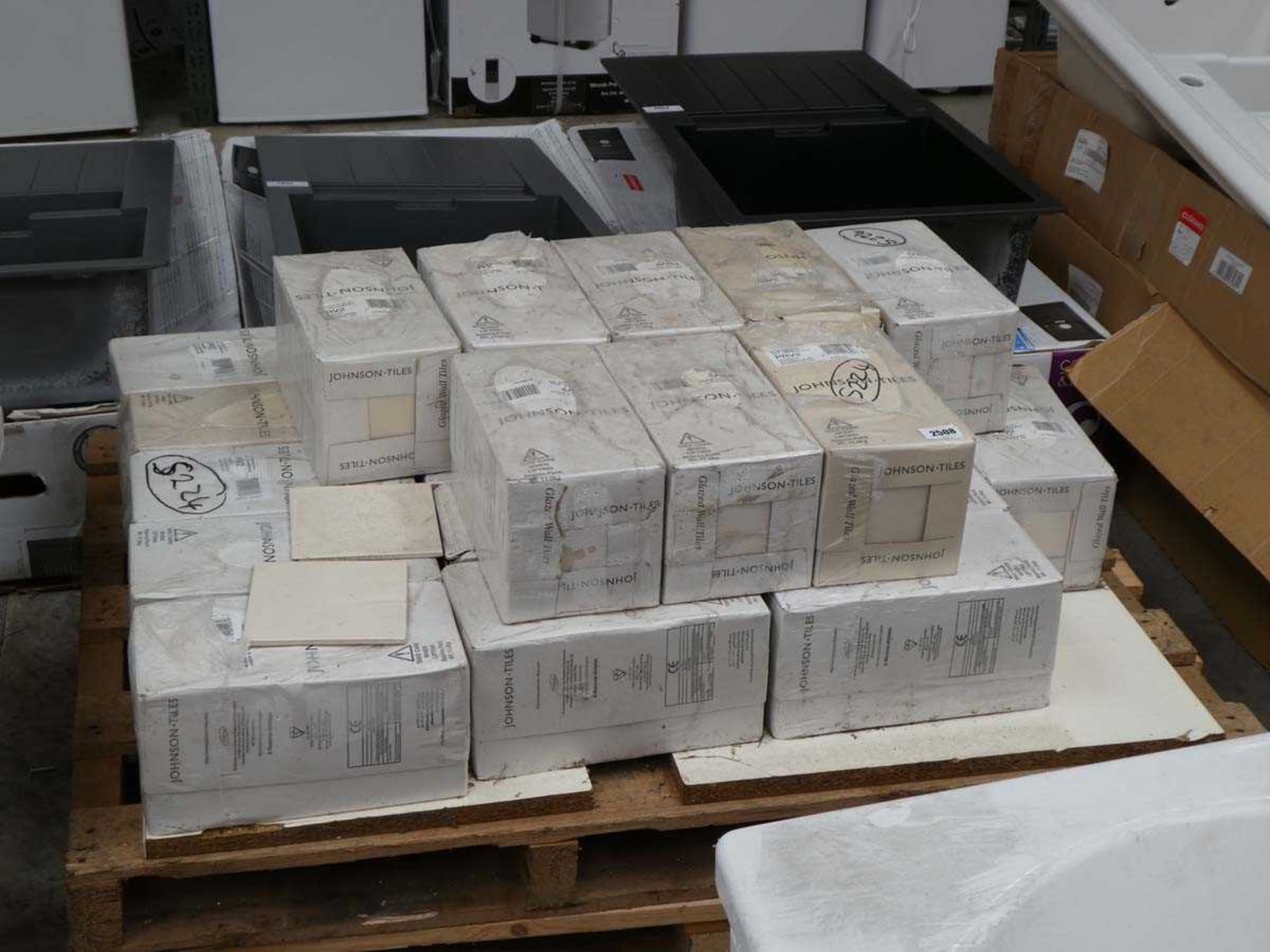 Pallet containing approximately 20 boxes of cream coloured glazed all tiles