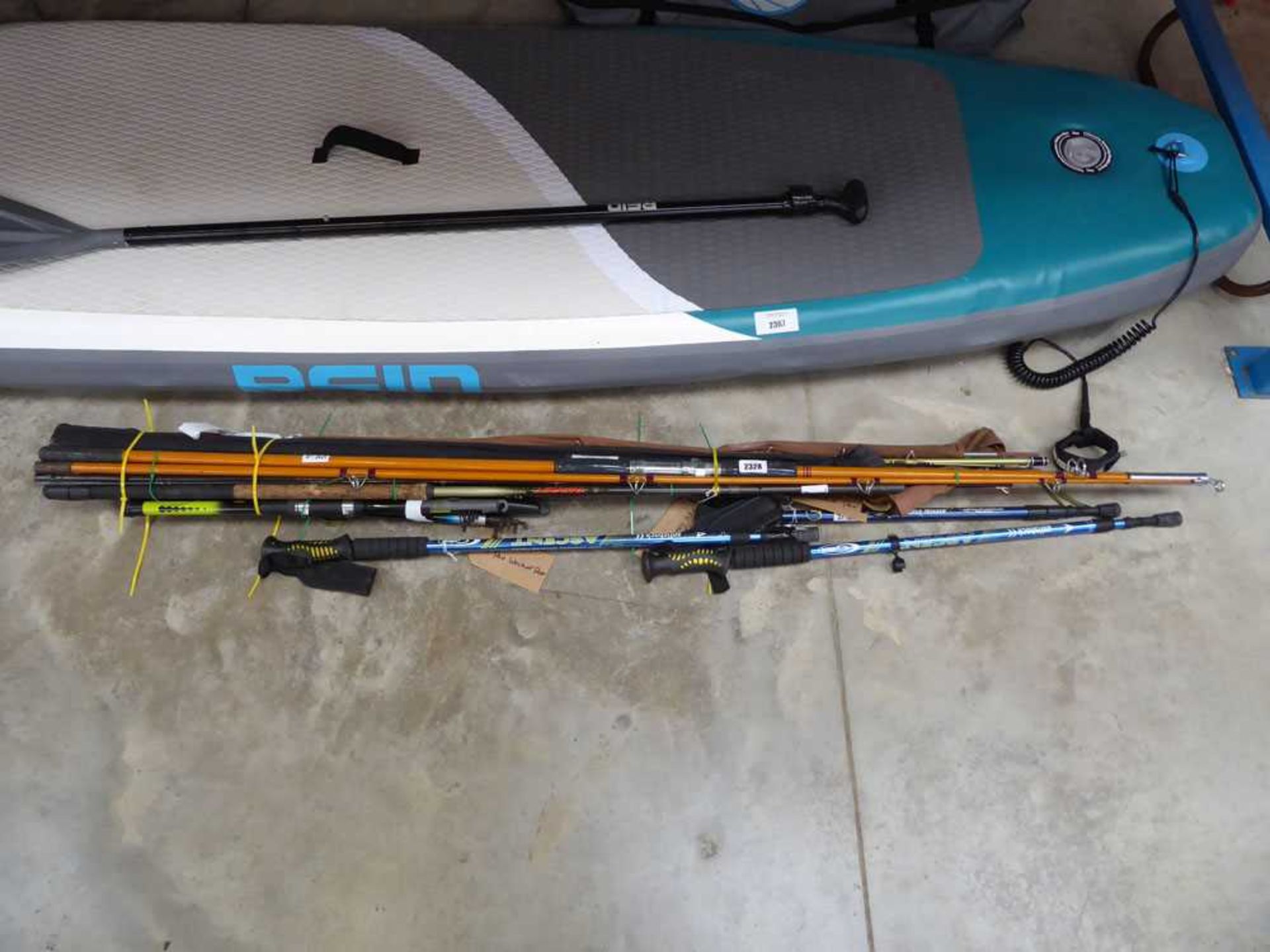 Bundle containing approx. 11 coarse and fly fishing rods, together with 3 walking poles