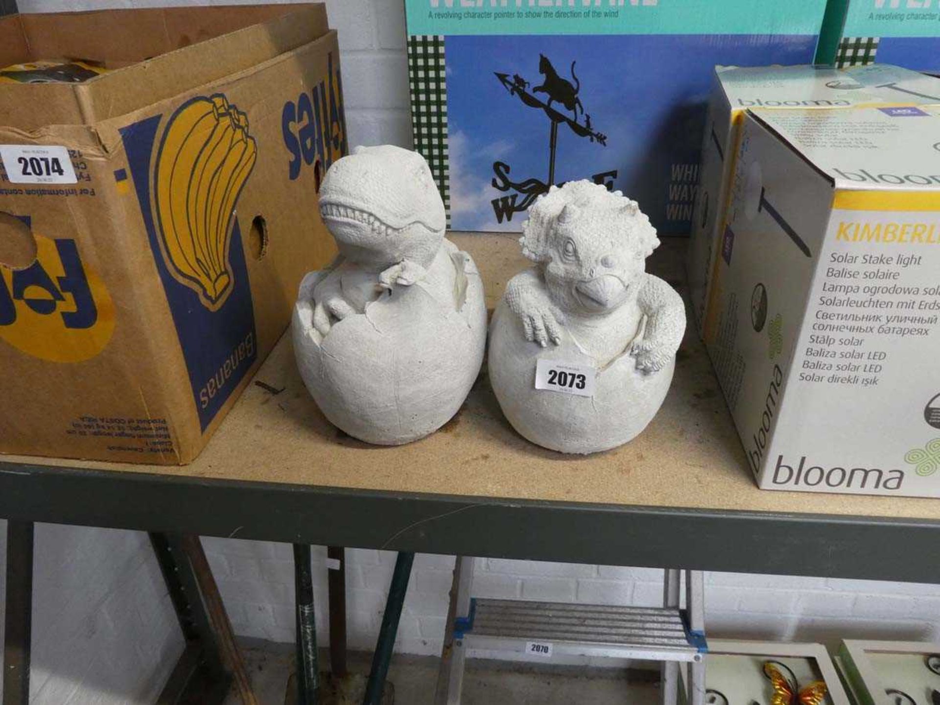 Pair of concrete hatching dinosaurs