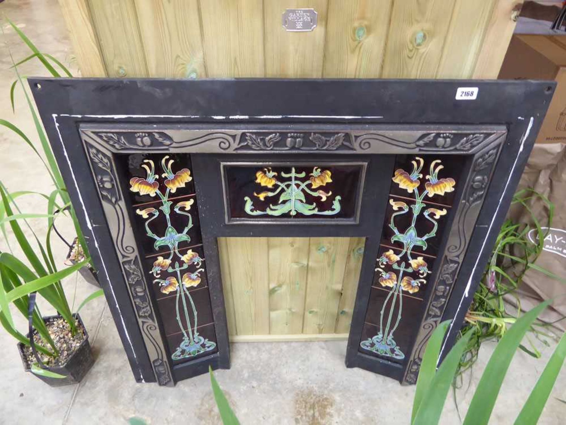 Black fireplace with inlaid decorative floral tiles (96.5 x100cm.)