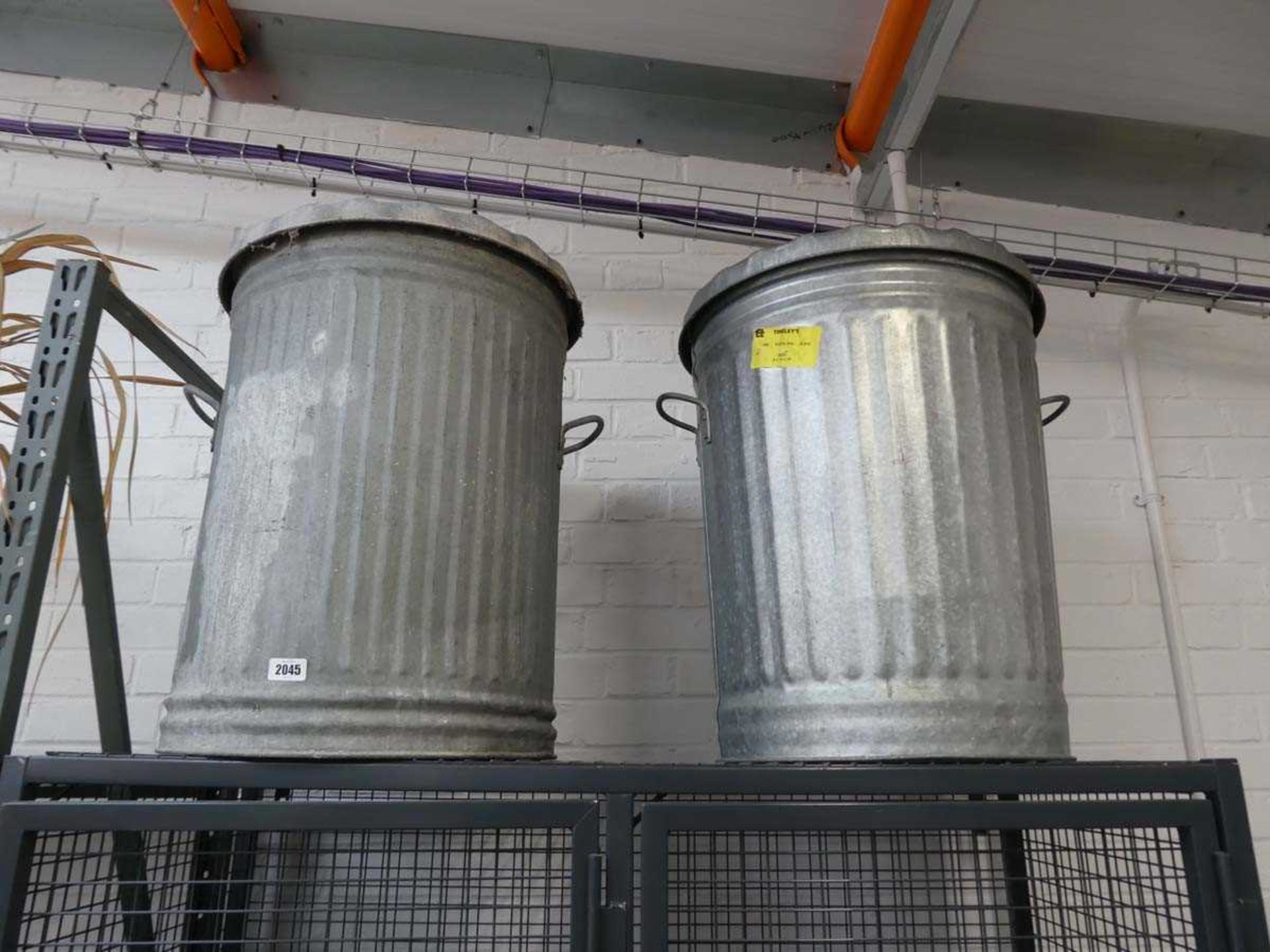 Pair of galvanised twin handled garbage cans with lids