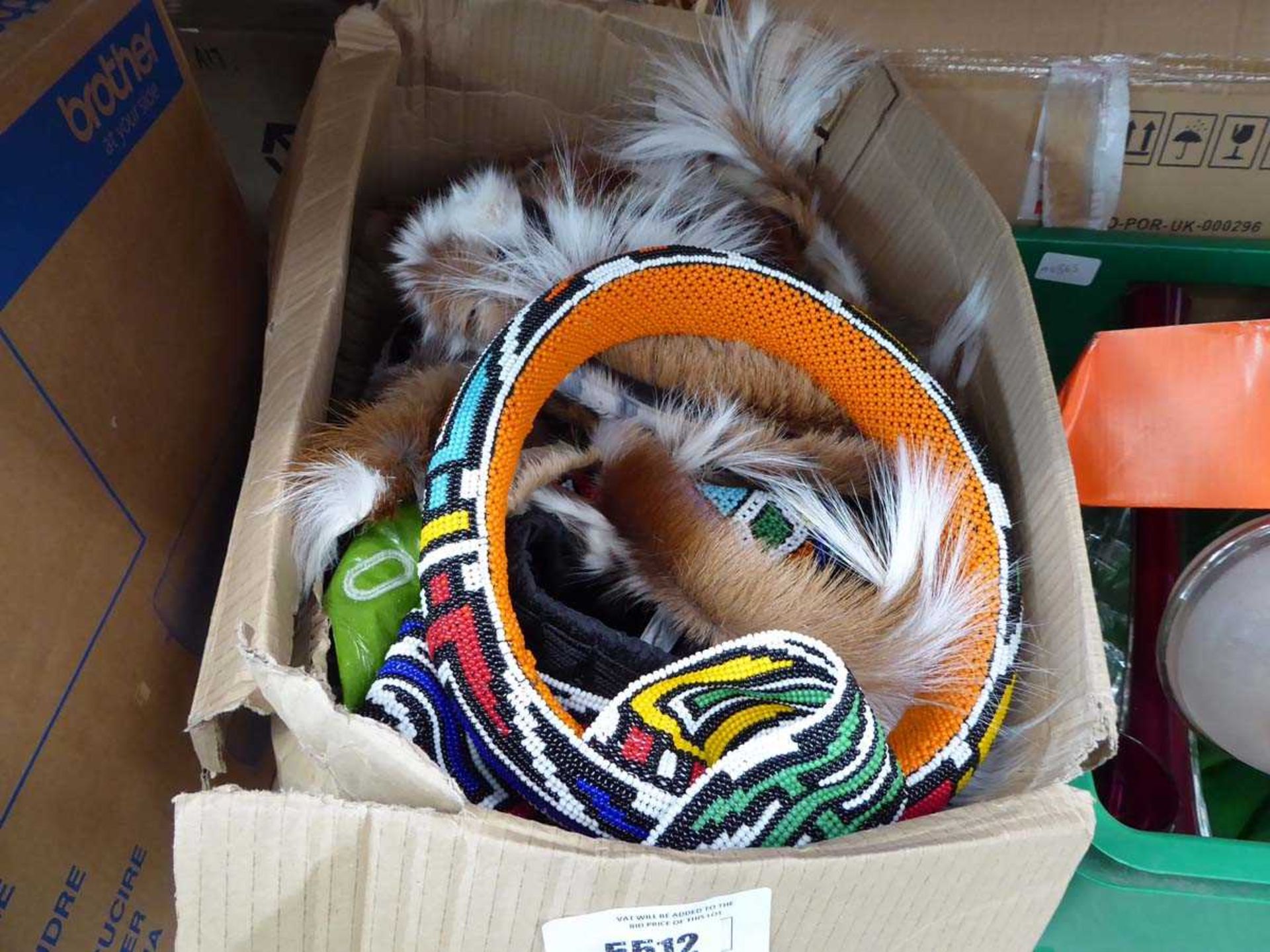 +VAT Box containing modern Zulu bead work and antelope skin head dresses