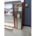 Two narrow rectangular and domed topped mirrors in natural wood and gilt frames