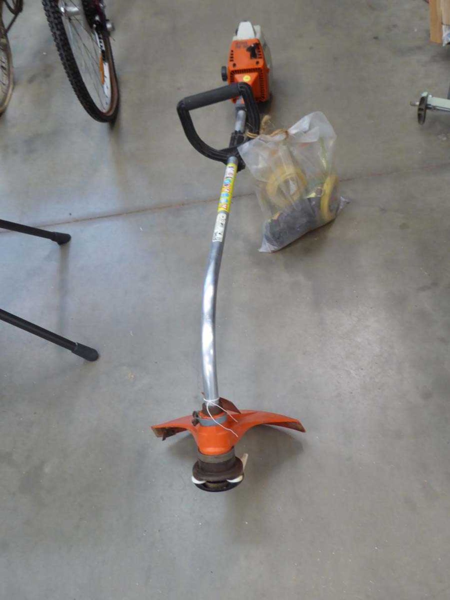 Stihl petrol powered bent shaft strimmer with accessories