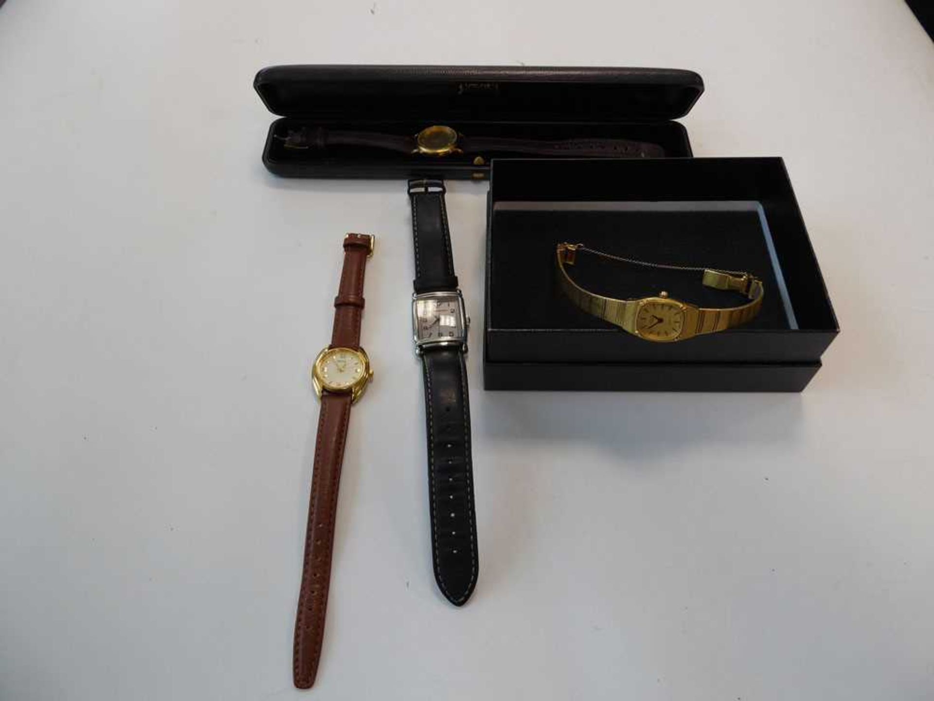 Yellow metal wristwatch, one other watch, and a cased watch