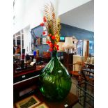 Carboy with artificial flowers