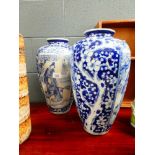 A pair of Chinese blue and white shouldered vases, each decorated with traditional figures at