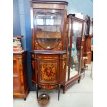 A Sheraton Revival mahogany, strung, marquetry and gilt-metal mounted corner cabinet, the top tier