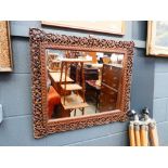 Mirror in heavily carved Indian frame