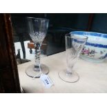 A 19th century drinking glass with a plain bowl and facetted stem, h. 15 cm and a smaller glass (