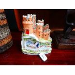 Two Staffordshire flatback figures, each modelled as a castle and a gentleman in a rowing boat, h.
