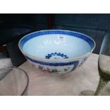 A Chinese Export fruit bowl decorated with foliate motifs within blue and white borders, d. 23 cm (