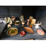 Cage containing pottery mugs, plus a jug, shallow dishes and a leaping trout