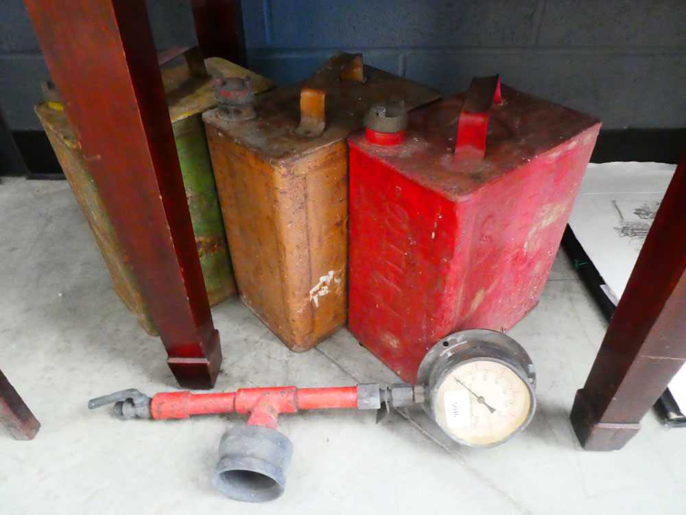 Three vintage fuel cans together with a Todd Oil Burners Ltd. pressure gauge