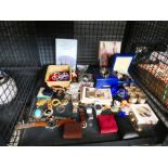 Cage containing postcards, beadwork, wrist watches and paperweights