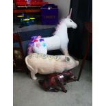 Two papier mâché pigs and fluffy unicorn